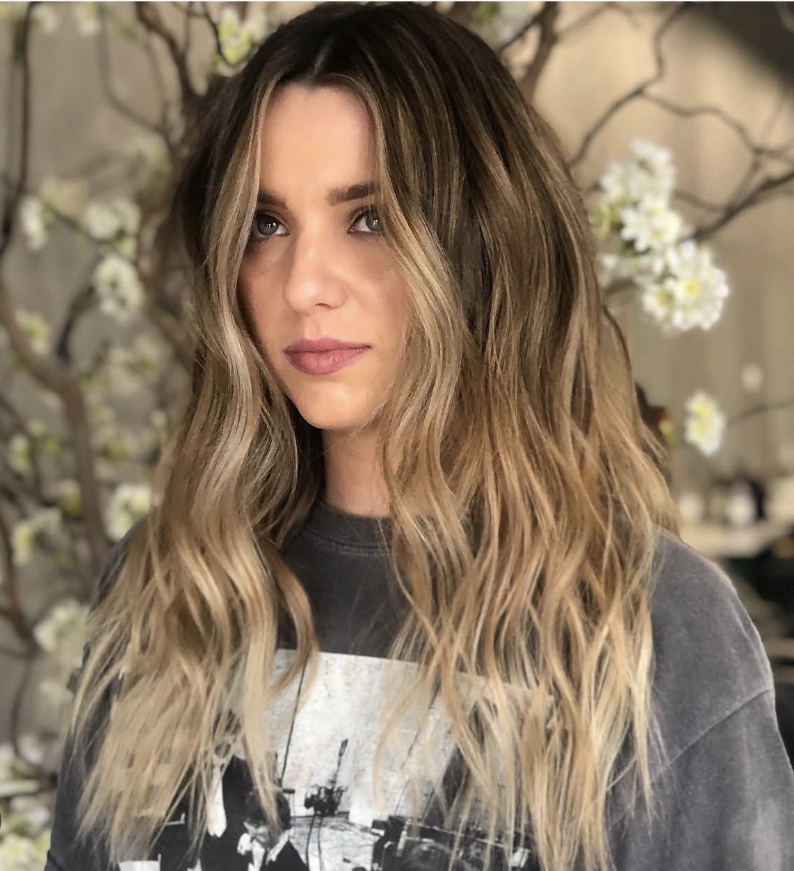 Brunette roots blending into warm blonde ends